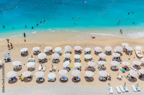 Peaople resting on the beach, umbrella rows, Kaputash, Turkey