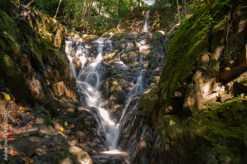 Fototapeta Naklejka Na Ścianę i Meble -  Ton Sai Waterfall in the tropical forest area In Asia, suitable for walks, nature walks and hiking, adventure photography Of the national park Phuket Thailand.