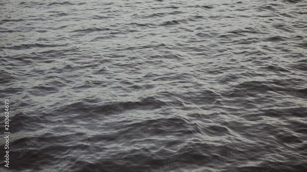 Cold sea in gray colors. Overcast weather. Small waves background close-up Cold sea in gray colors. Overcast weather. Small waves background close-up
