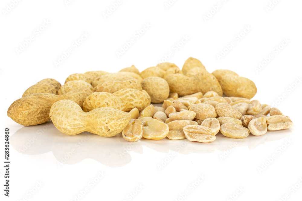 Lot of whole lot of halves of natural yellow peanut isolated on white background Lot of whole lot of halves of natural yellow peanut isolated on white background