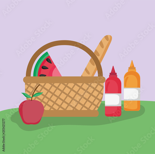 wicker basket fruit bread and sauces picnic in the park