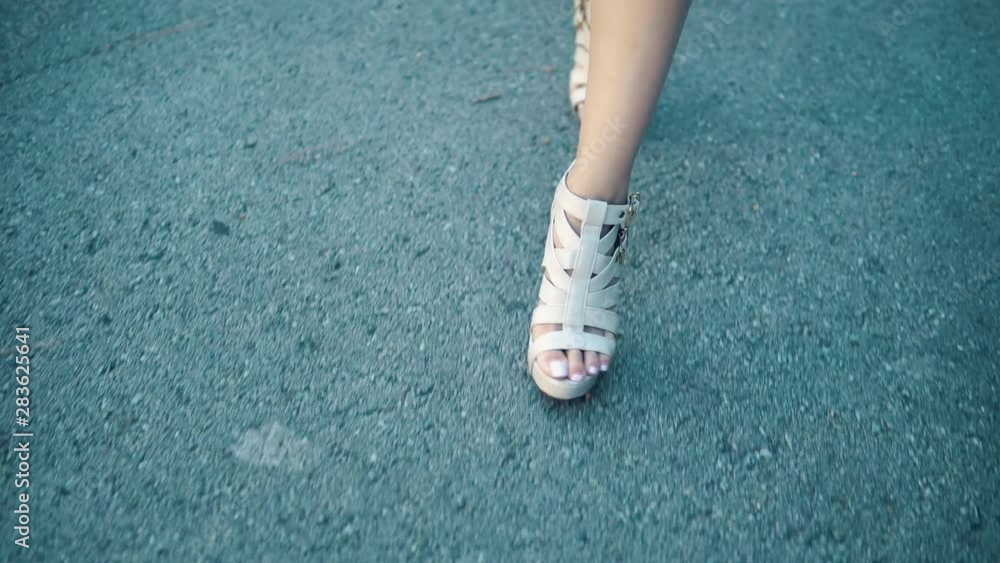 closeup shot of model legs walking down catwalk in the city closeup shot of model legs walking down catwalk in the city