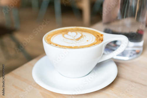 Cinnamon Latte in white mug on table at coffee shop