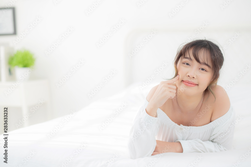 Portrait beautiful young asian woman smile while wake up healthy and wellness at morning in the bedroom, beauty asia girl lying skin care and makeup cosmetic with happy, lifestyle and relax concept. Portrait beautiful young asian woman smile while wake up healthy and wellness at morning in the bedroom, beauty asia girl lying skin care and makeup cosmetic with happy, lifestyle and relax concept.