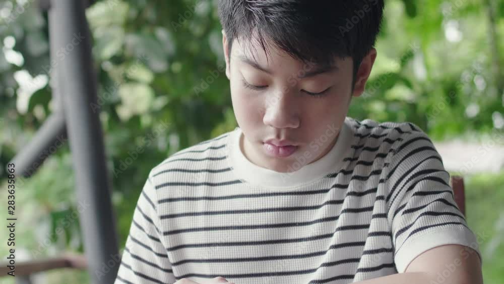 Asian boy playing on tablet computer with smile face. Asian boy playing on tablet computer with smile face.