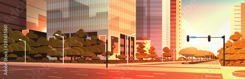 beautifil city street asphalt road with traffic light high skyscraper modern cityscape sunset background flat horizontal closeup