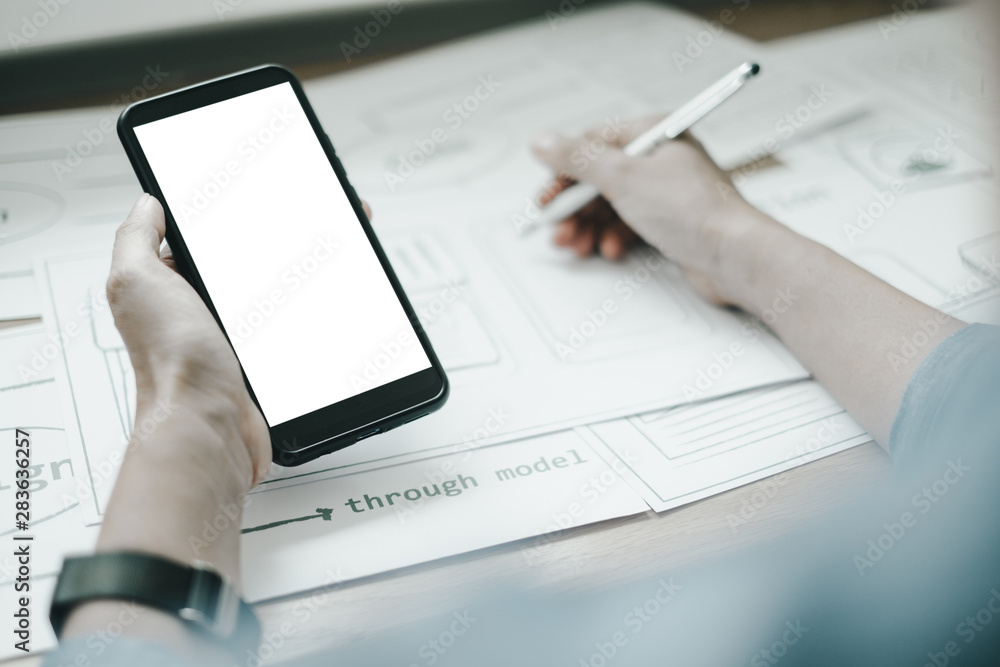 Fototapeta premium Mockup image of ux graphic designer creative smartphone application process development interface for web mobile phone, mockup concept