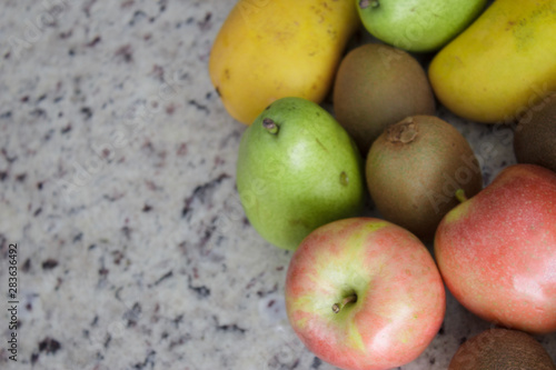 Fruits (kiwi, apple, bananas and pears) on the left