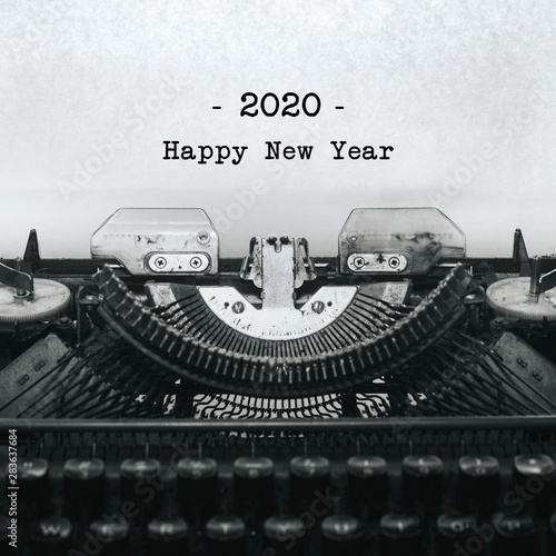 Vintage typewriter on white background with text HAPPY NEW YEAR 2020.