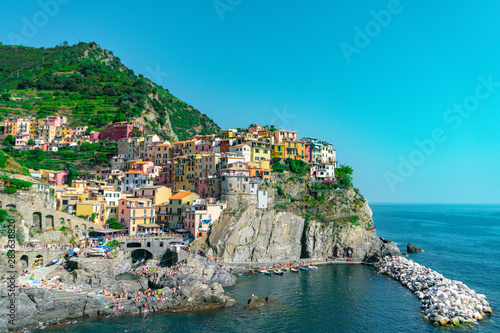 Amazing view of Manarola village in Cinque Terre  Italy. Sunny day and blue sky of an afternoon in the European summer. Unesco World Heritage Site