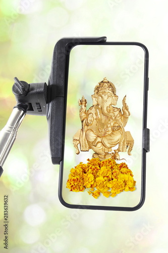 Selfie stick with smartphone isolated with hindu god ganesha