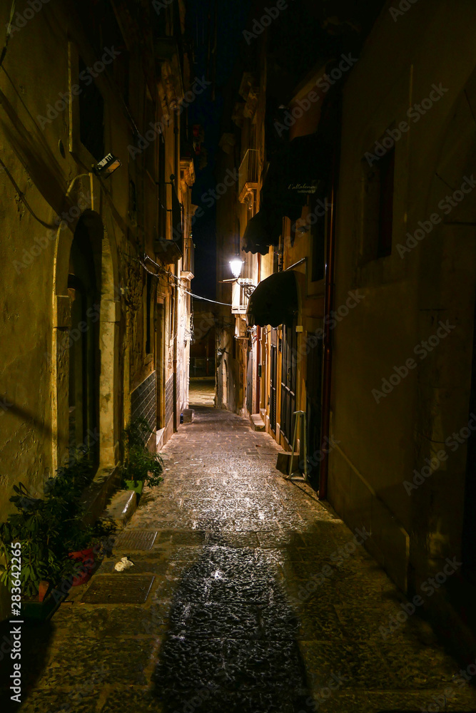 Syracuse, Sicily, Italy One of the many narrow alleys on Ortygia island at night.