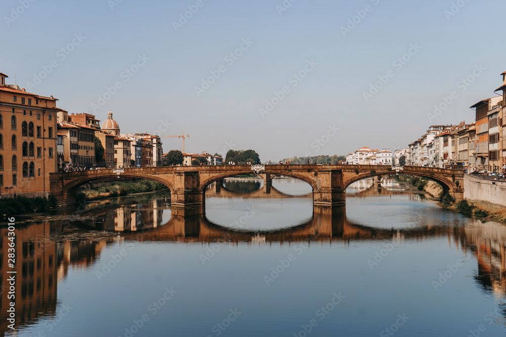 Ponte Santa Trinita bridge over the Arno river | FLORENCE, ITALY - 14 SEPTEMBER 2018.