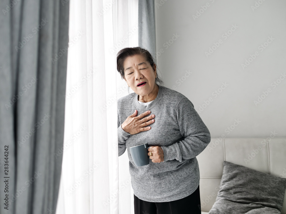 Asian senior woman having heart attack while staying at home alone, lifestyle concept. Asian senior woman having heart attack while staying at home alone, lifestyle concept.