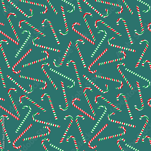 A seamless christmas vector pattern with striped candy canes on a teal background. Surfface print design.