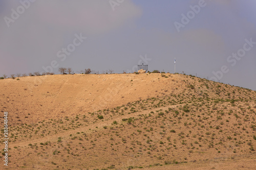 Small hill in desert with Chanukiah under sky