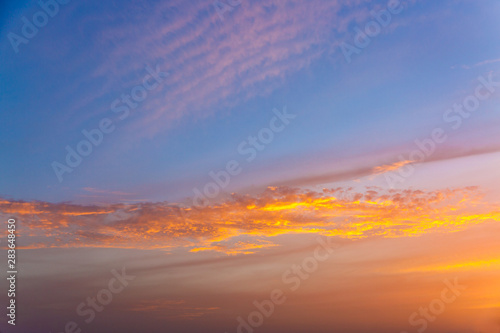 Golden clouds at sunset illuminated by the sun