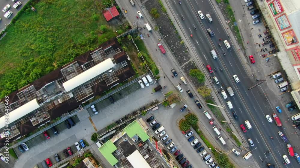 Top down aerial view of some place in Pasig toward the floodway and the vehicles passing through the bridge. Top down aerial view of some place in Pasig toward the floodway and the vehicles passing through the bridge.