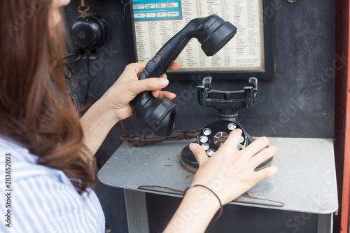 Woman finger dialing a rotary dial telephone. woman hand hanging up the handset © bong