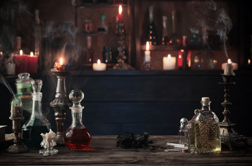 magic potions in bottles on wooden background