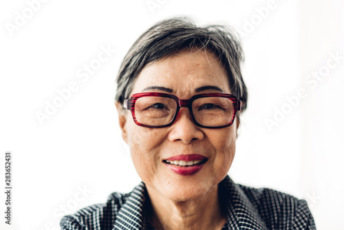 Portrait of happy senior adult elderly asia women smiling and looking at camera on white background.Retirement concept
