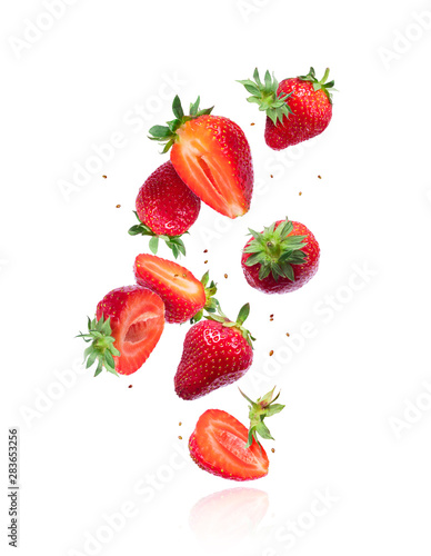 Whole and sliced fresh cherries in the air, isolated on a white background photo