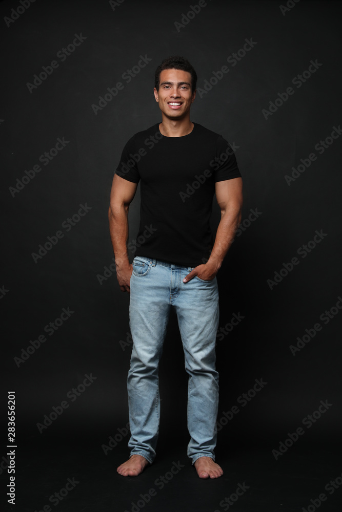 Handsome young African-American man on black background Handsome young African-American man on black background
