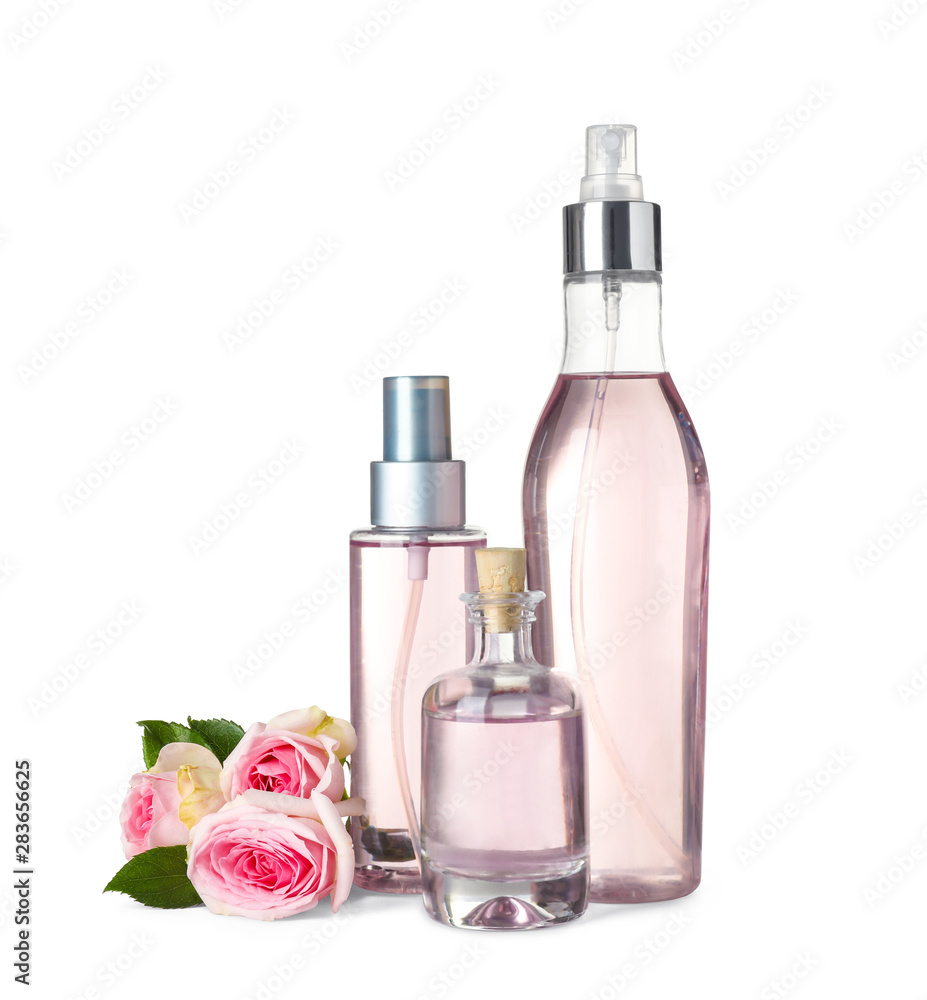Bottles of essential oil and roses on white background Bottles of essential oil and roses on white background