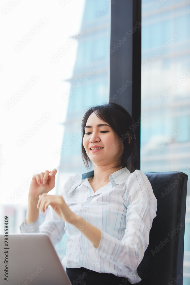 Asian business woman stretching her muscles for flexibility in the treatment of office syndrome.