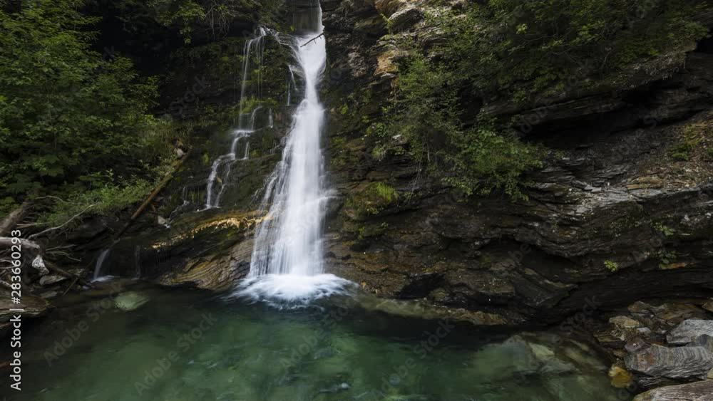 Smooth waterfall in lush green forest 4K time lapse Smooth waterfall in lush green forest 4K time lapse