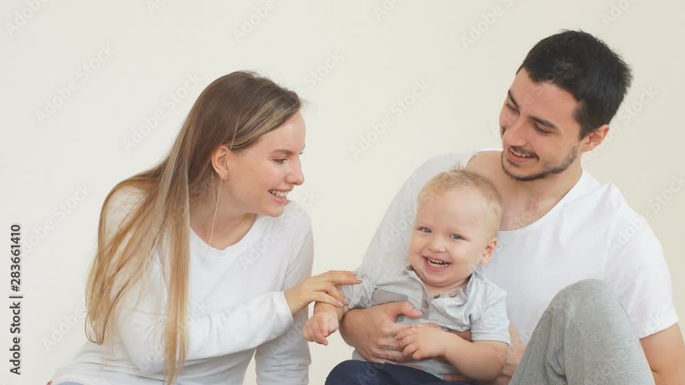 Happy young family spending time with a young son in new home. Happy young family spending time with a young son in new home.