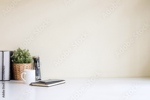 Mockup workspace desk and copy space books,plant and coffee on white desk. photo