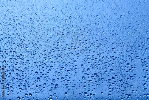 Water drops on glass, natural blue texture
