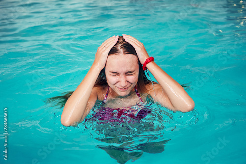 Girl swimming and relaxing in swimming pool