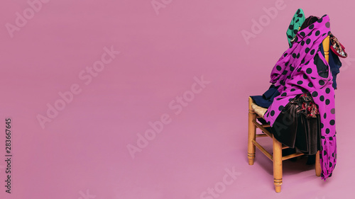 Flamenco dresses on chair with pink background photo