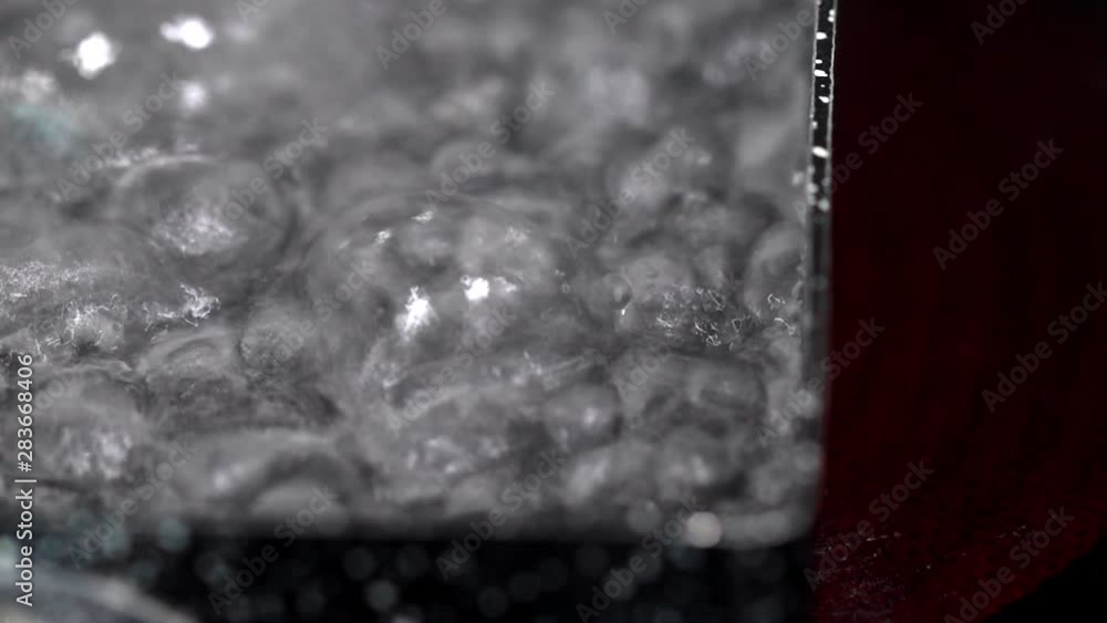 boiling water in pan on electric stove in kitchen, hot water with bubbles boiling water in pan on electric stove in kitchen, hot water with bubbles
