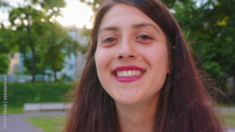 A young pretty lady smiling outdoors. Emotion A young pretty lady smiling outdoors. Emotion