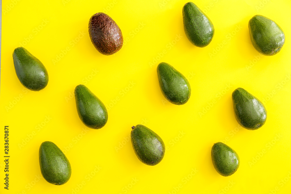 Fresh ripe avocados on color background