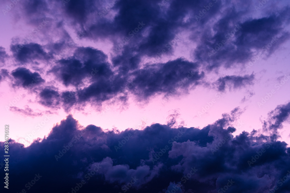 Obraz premium Blue hour sky clouds background. Beautiful landscape with clouds and purple sun on sky