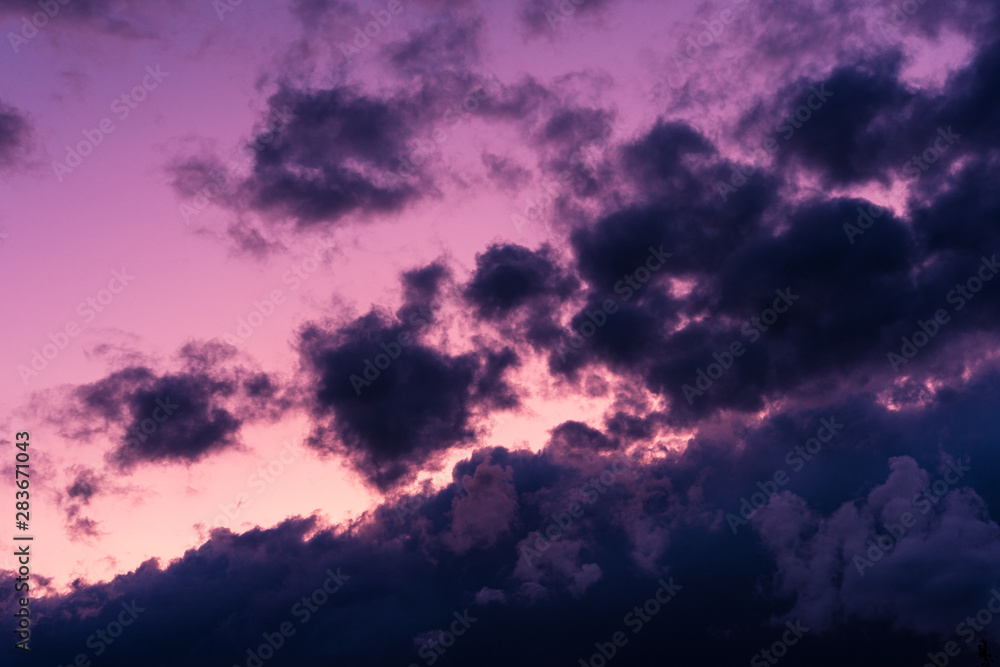 Blue hour sky clouds background. Beautiful landscape with clouds and purple sun on sky