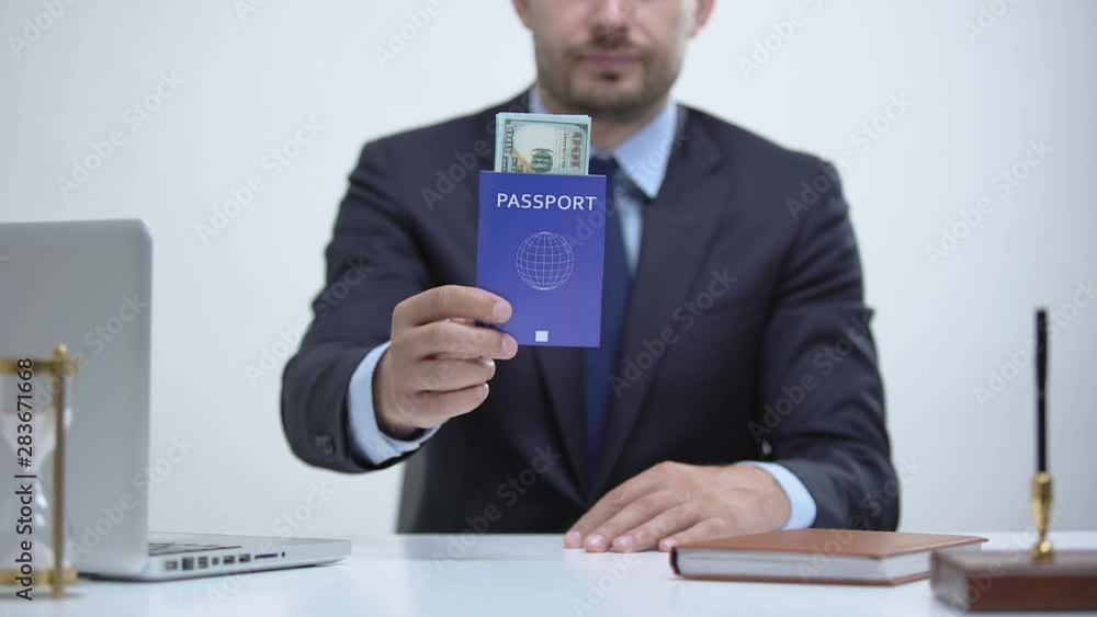 Migrant officer holding passport with dollars, payment for id card services Migrant officer holding passport with dollars, payment for id card services