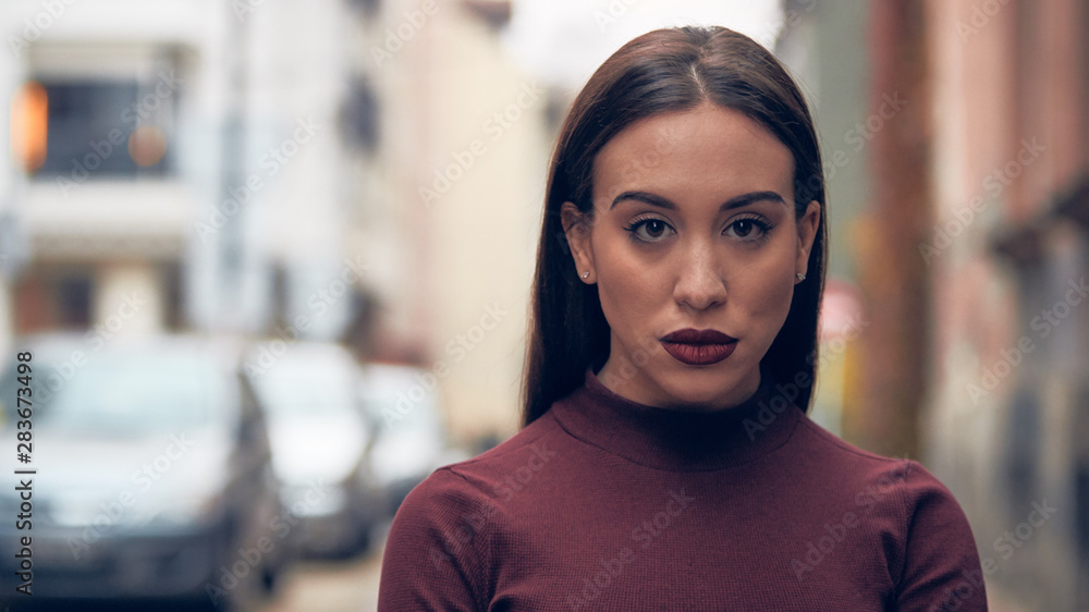Obraz premium Sad young woman posing on the street.