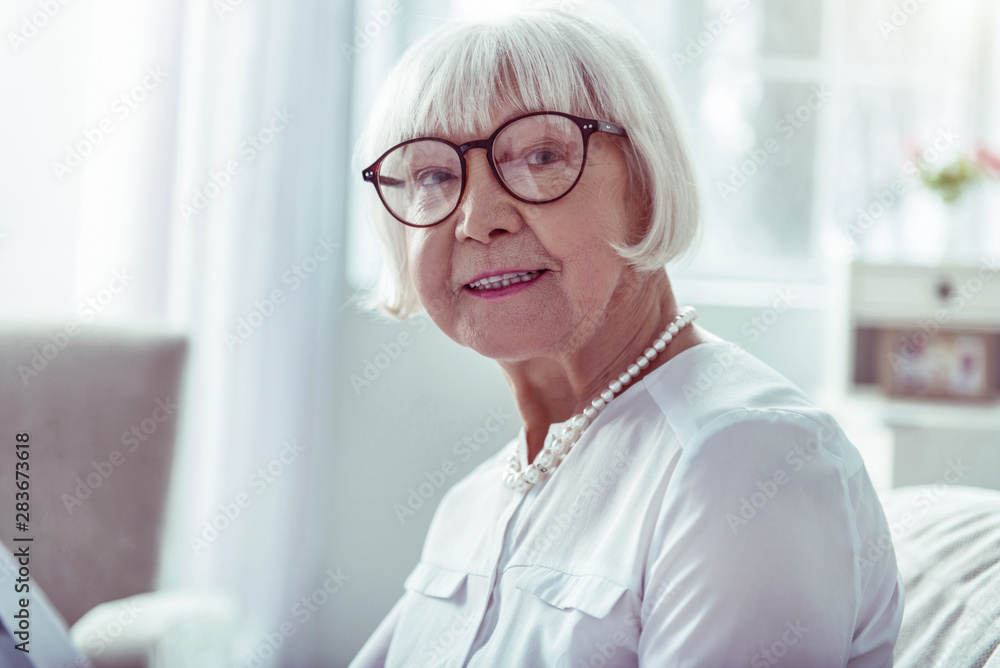 Close up of beaming elegant elderly lady smiling after family day Close up of beaming elegant elderly lady smiling after family day