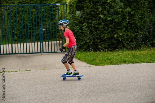Side view of boy riding a  skateboard.