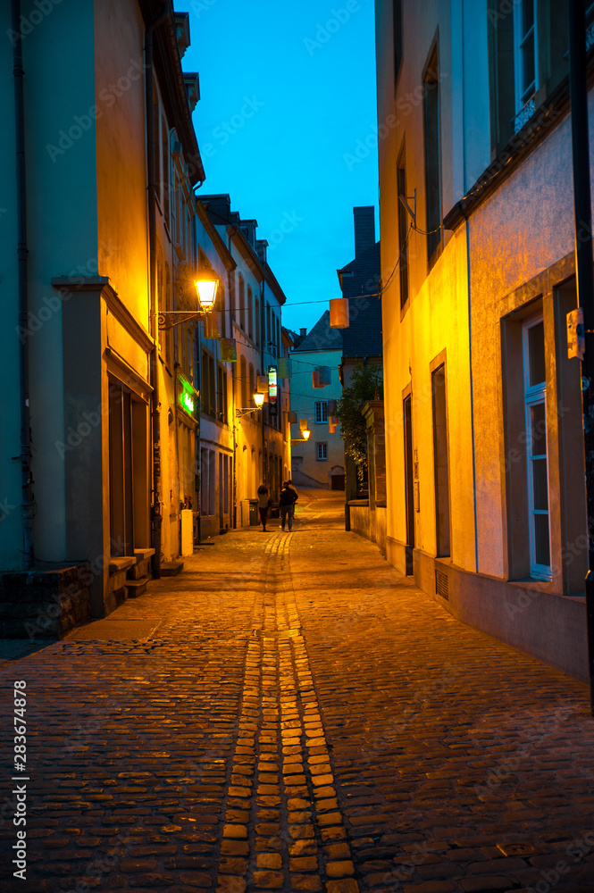 Empty street scene with yellow lights in a moody night