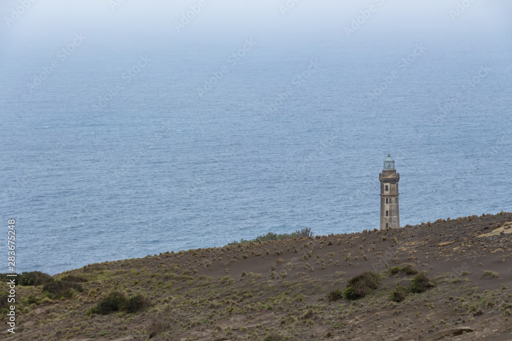 Lighthouse of Ponta dos Capelinhos on western coast on Faial island, Azores, Portugal. Last Capelinhos volcano eruption was in 1957.