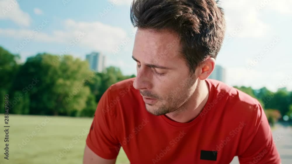 Handheld video shows of man catching a short break during running Handheld video shows of man catching a short break during running