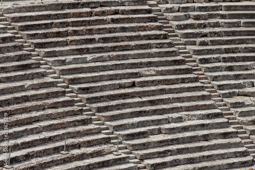 Obraz na płótnie Stairs of the ancient theatre of Epidaurus in the Epidaurus town, on Peloponnesus peninsula, Greece. The theater was dedicated to the ancient Greek God of medicine, Asclepius. Stairs closeup. w salonie