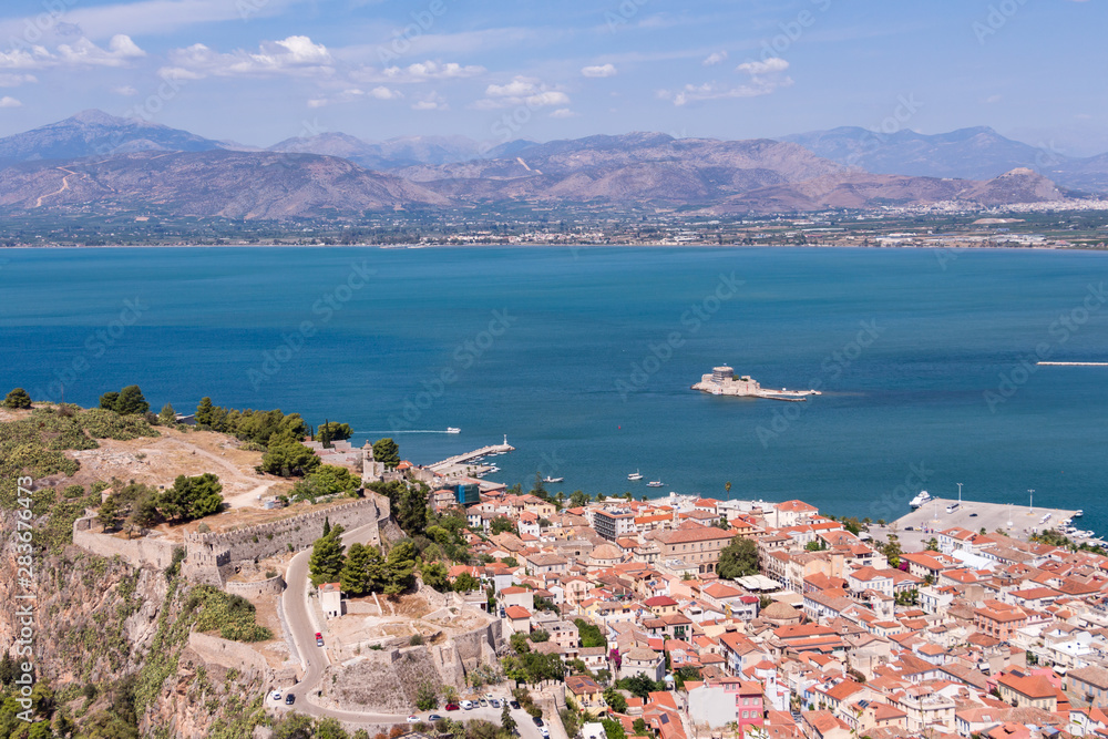 Aerial view from famous Venetian Palamidi fortress and Bourtzi Castle on a small islet in the city of Nafplio former capital of Greece, Peloponnese. Aerial view from famous Venetian Palamidi fortress and Bourtzi Castle on a small islet in the city of Nafplio former capital of Greece, Peloponnese.