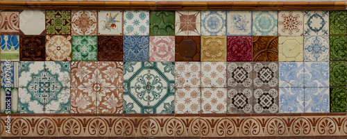 Beautiful traditional Portuguese colorful tiles covering the building wall. Azulejo. Background, wallpaper.